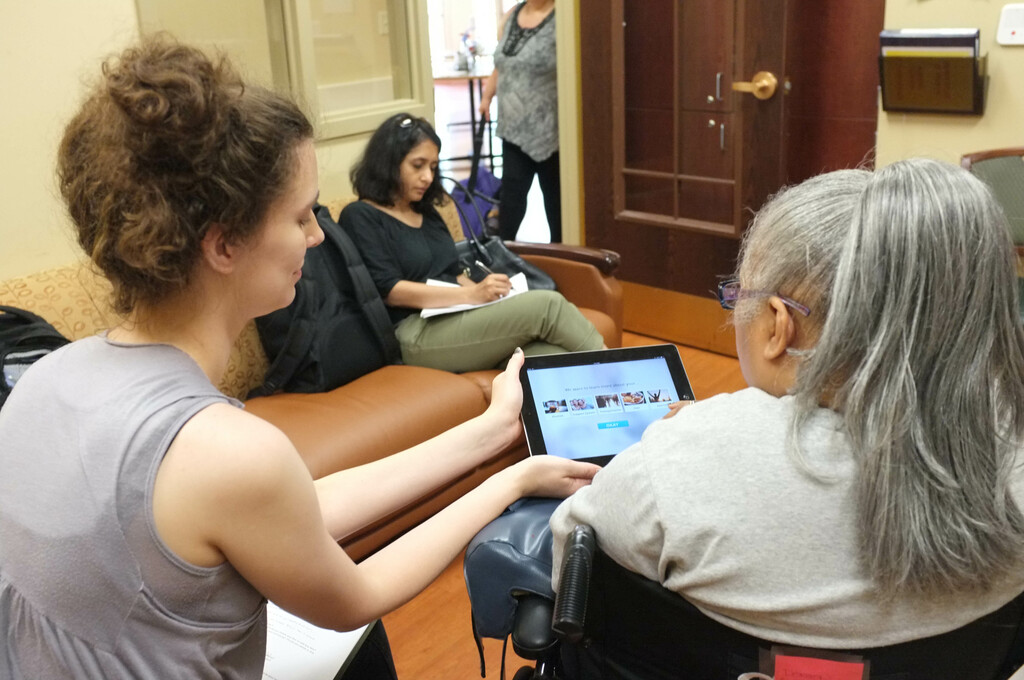 Anna administering a usability test with a former patient, and Tina taking notes.